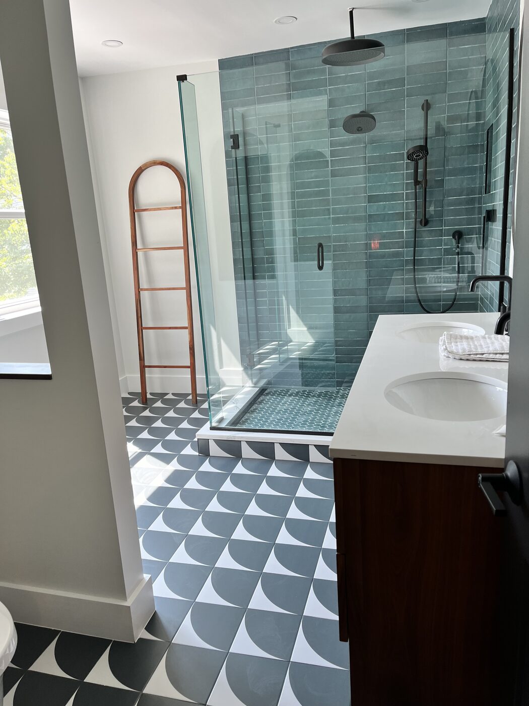 Walk-in shower with teal stacked tile and black fixtures in a remodelled Plano bathroom