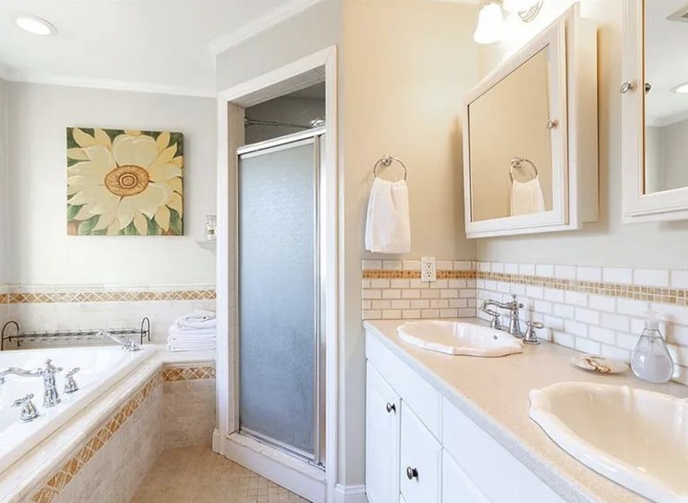 Plano bathroom before remodelling: scalloped shell sinks on a laminate top, corner jetted tub and a narrow frosted-glass shower stall